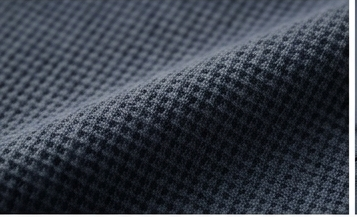 Close-up of textured dark blue fabric with a subtle pattern